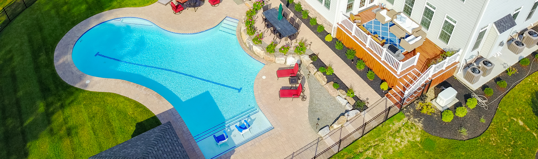 A large deck overlooking the pool provides another generous seating area for conversation and easy access to the home.