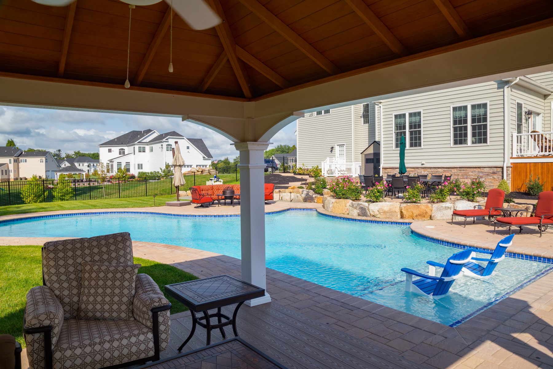 The curved poolside conversation area offers sunshine on warm days and a fire pit to warm you on cool evenings.